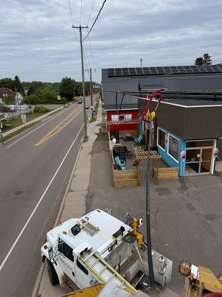 Tinuum bucket truck servicing fibre infrastructure on a New Brunswick main street