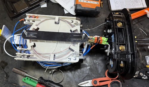 Tinuum technician precision-splicing fibre optic cable inside the splice truck, Salisbury NB